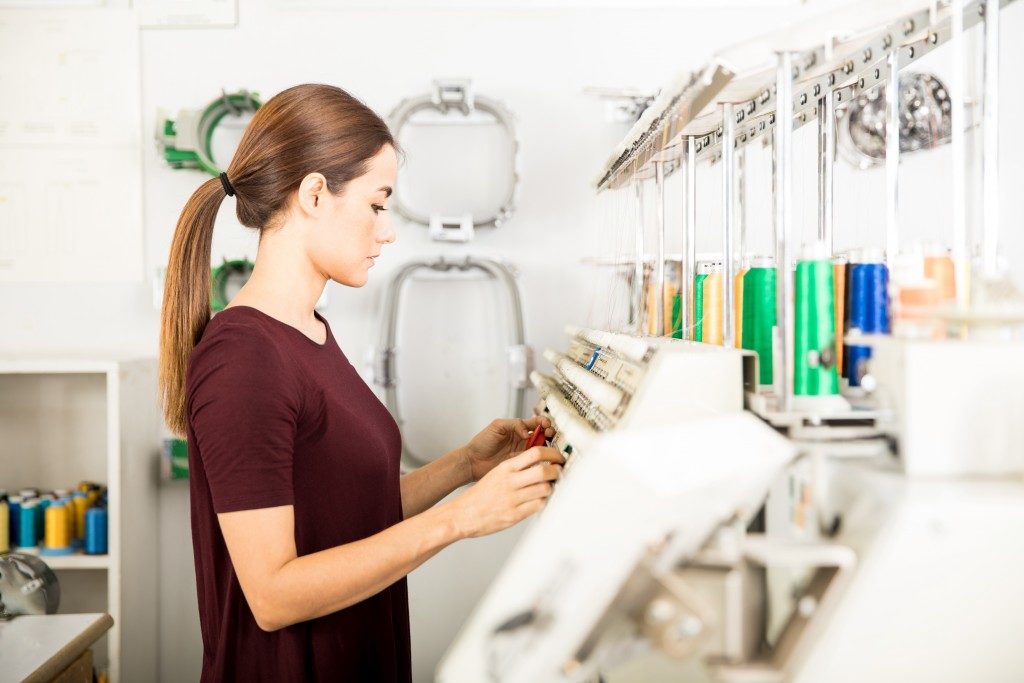 Woman setting up embroidery machine